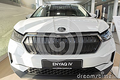 white electric Å koda â€ŽEnyaq electric car, Czech EV manufacturer, Volkswagen AG in showroom, Green Mobility, technology in Editorial Stock Photo